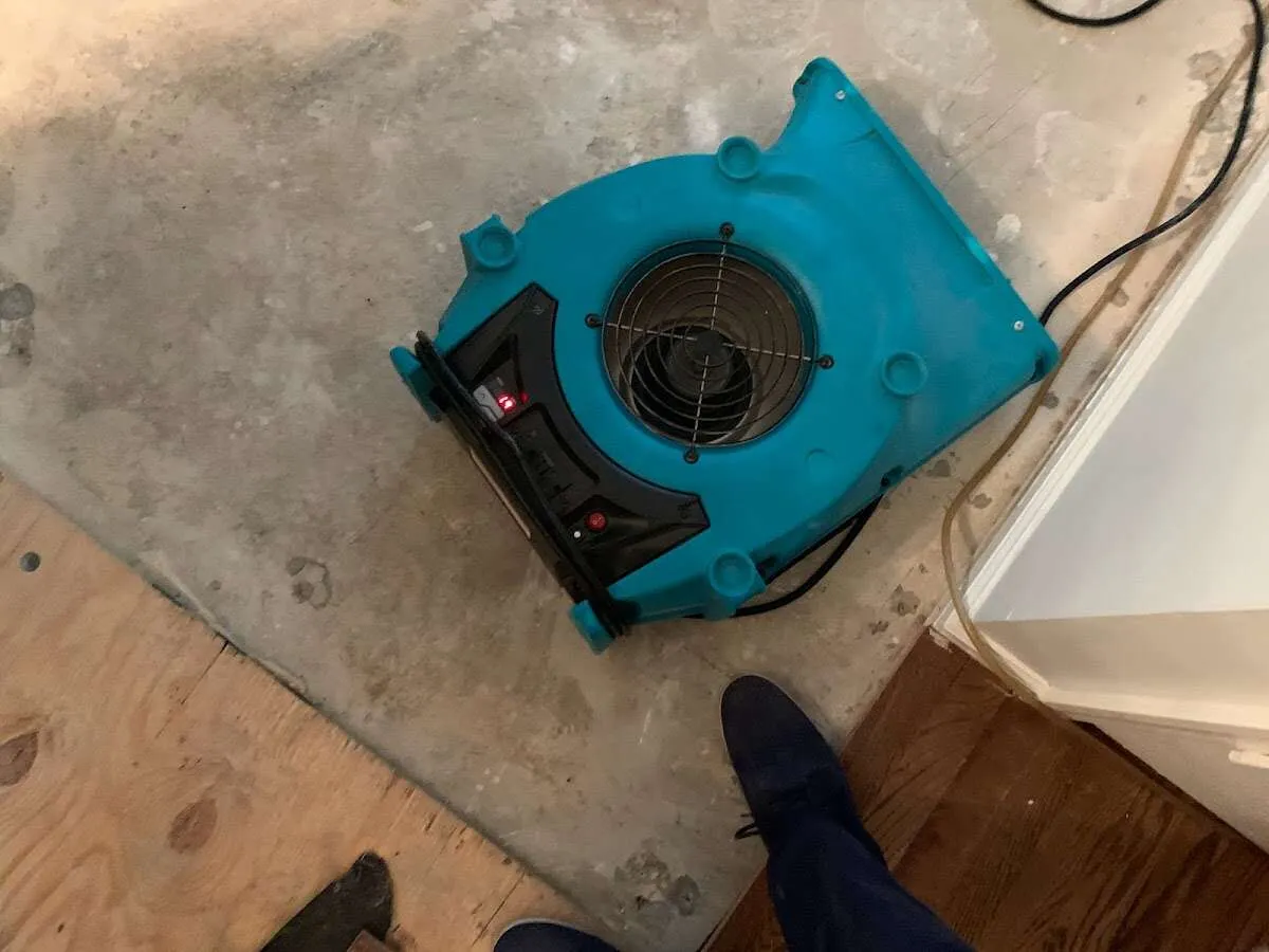Air mover drying subfloor during Commercial Water Damage Restoration in Lilburn